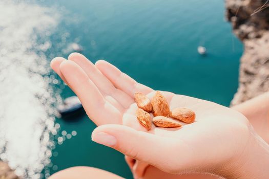 Unrecognizable caucasian woman eating young milky almond nuts. Healthy vegan food