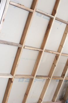 Wall studding with timber framework for attaching plasterboard during construction