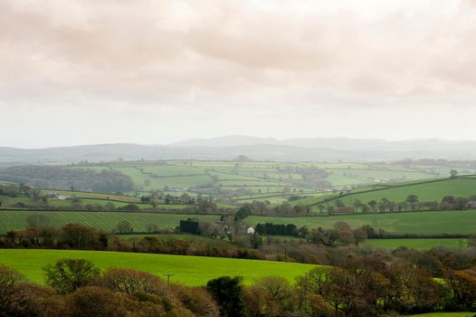 Cornwall country landscape with gently rolling hills and lush green agricultural fields and pastures