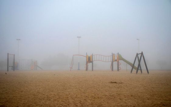 Playground on foggy morning in the park.