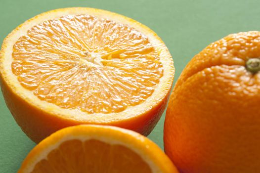 Close-up of half of orange on green background