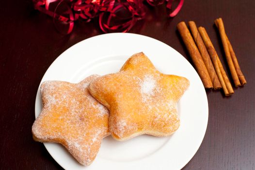 Star shaped sugared doughnuts on a plate for a festive seasonal Christmas dessert or snack