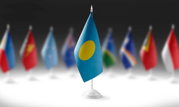 The national flag of the Palau on the background of flags of other countries.