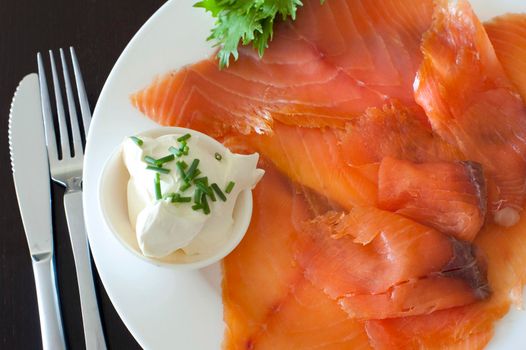 Gravlax, or thinly sliced cured smoked salmon with cream cheese and chives served as an appetizer