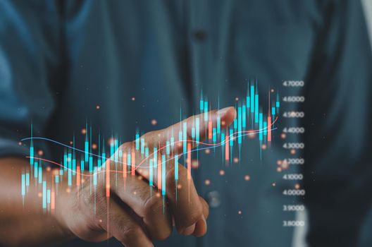 Finance and business investment concept. Stock and crypto investment funds.Businessman analyzing or trading Forex graphs of financial data candlestick chart.