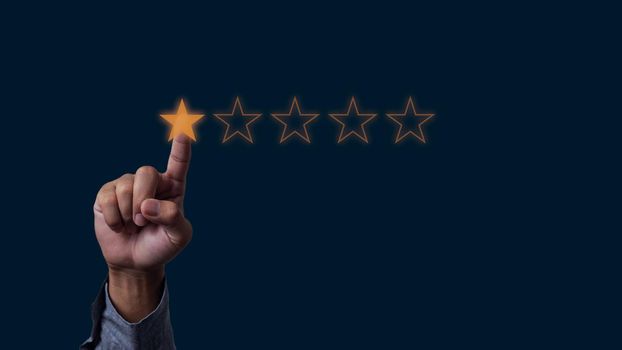 Businessman hand touches five stars rating feedback rating and positive customer review experience on virtual screen.