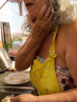 cleaning a raw adriatic cuttlefish at home in Numana, Marche, Italy