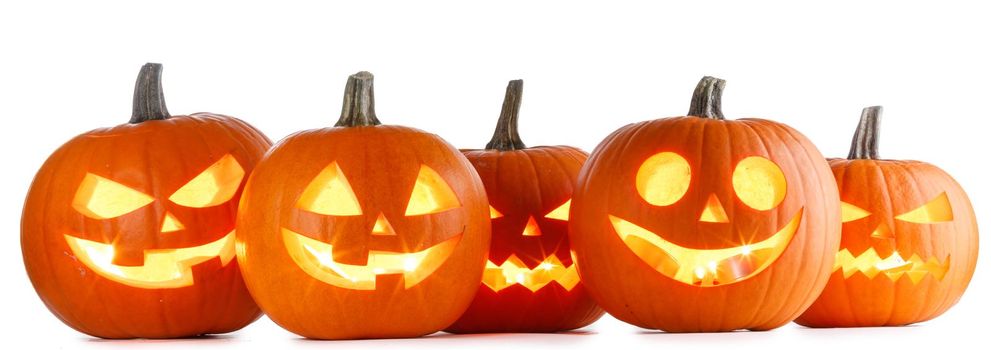 Five Halloween glowing lantern pumpkins in a row isolated on white background