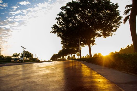Jogging and cycling tracks in Al Warqa park, Dubai, UAE early in the morning. Lamp post powered by solar panels can be seen in the picture. Outdoors