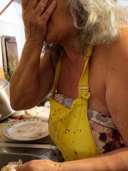 cleaning a raw adriatic cuttlefish at home in Numana, Marche, Italy