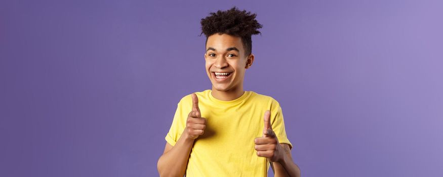 Believe in you. Portrait of cheerful young optimistic guy encuraging to keep going, pointing fingers at camera with happy upbeat smile, picking someone, praising or complimanting.