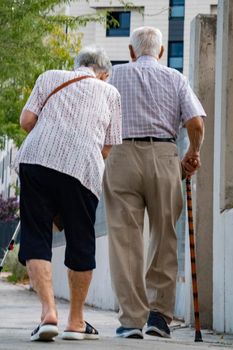 Elderly couple walking together in the street with happy lifestyle, and romantic. Always together and ever concept