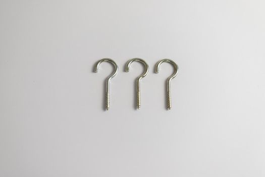 Question mark of screws on isolated white background or conceptual sign