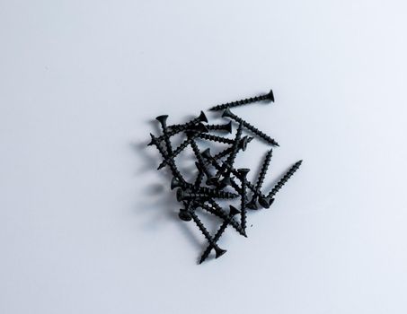 Pile of black screw on isolated white background