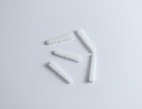 White plastic dowels on isolated white background