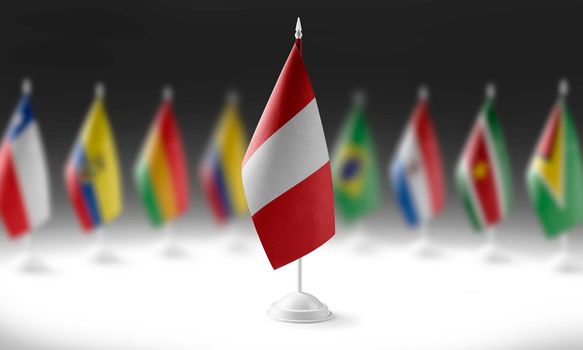 The national flag of the Peru on the background of flags of other countries.