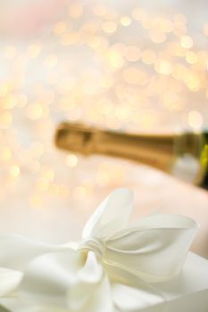 Romantic celebration, lifestyle and luxury present concept - The bottle of champagne and holiday gift box