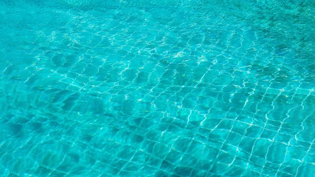 Abstract background Patterns Ripped water Surface swimming pool Light Reflection Vibrant blue green.