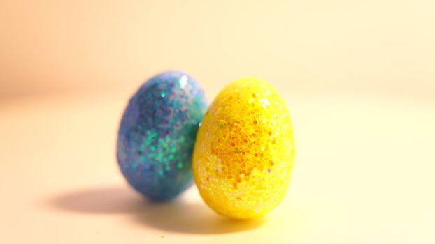 Colorful Easter eggs rotating in rows in a seamless loop on a light background.
