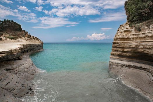 the concept of recreation and wellness for children and adults to breathe the sea air, take natural vitamin D from the sun lying under the blue sky or making a water voyage on a boat or a speedboat to enjoy the splash of waves and catch the magical shades of water in Paleokastritsa on the island of Corfu Corfu in Greece. High quality photo