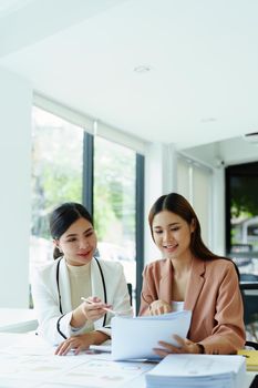 Portrait of a young Asian businesswoman discussing how to analyze profitability and marketing against digital competitors.