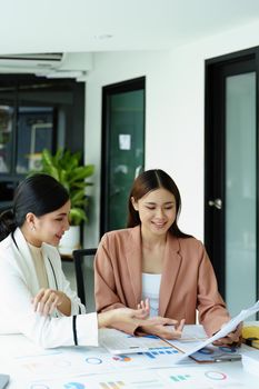 Portrait of a young Asian businesswoman discussing how to analyze profitability and marketing against digital competitors.