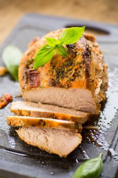 Baked sirloin turkey meat homemade with spices, on a wooden table.