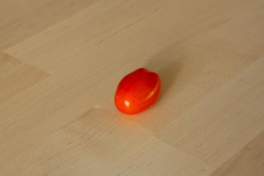 Fresh cherry tomato isolated on wooden background. High quality photo