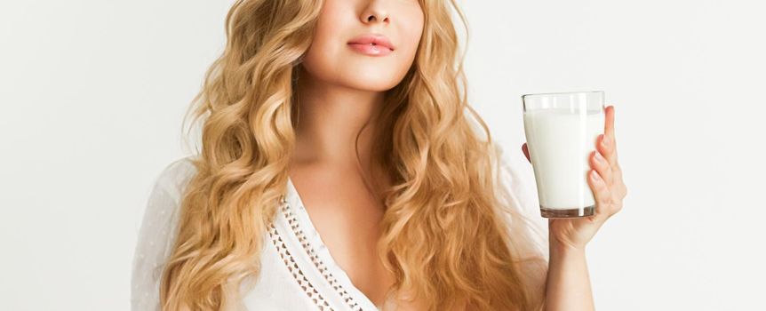 Diet, health and wellness concept, woman holding glass of milk or protein shake cocktail