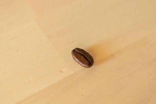 Close-up of Roasted coffee bean on wooden background. High-quality photo
