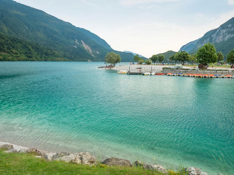 Yacht and paddleboard port at beautiful Molveno town and Molveno lake, an alpine lake in Trentino, Italy 