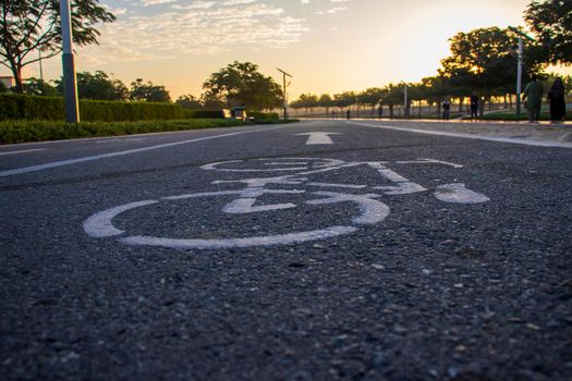 Jogging and cycling tracks in Al Warqa park, Dubai, UAE early in the morning. Lamp post powered by solar panels can be seen in the picture. Outdoors