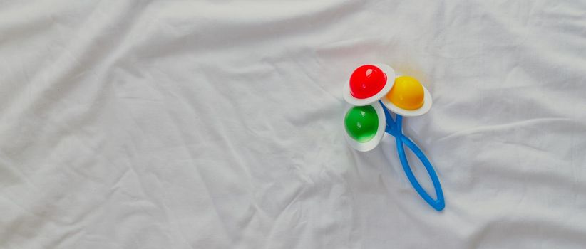 Baby rattle on a white background copyspace. Educational toys for kids. Toy copyspace . Article about children
