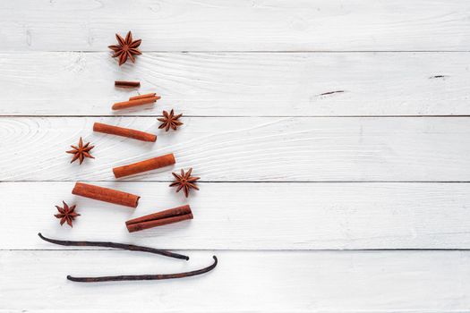 Christmas tree made of spices, white wooden background, top view, copy space