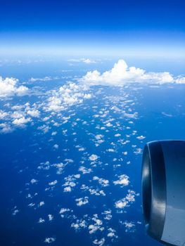 Travel, cloudscape and natural environment concept - View from the airplane window, sky and ocean blue