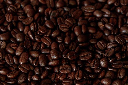 Brown Roasted Coffee Beans Closeup On Dark Background. High quality photo