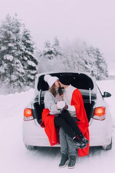 A couple in love in the trunk of a car lifestyle , An article about couples in love. An article about winter . Valentine's day. Love