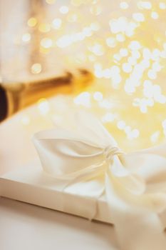 Romantic celebration, lifestyle and luxury present concept - The bottle of champagne and holiday gift box