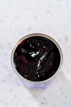 Opened a metal can with blueberry pie filling on the counter.