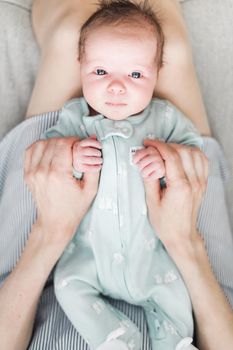 Lifestyle portrait of a newborn, three weeks old baby girl.