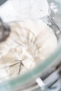 Mixing ingredients in kitchen mixer to bake Easter meringue cookies.