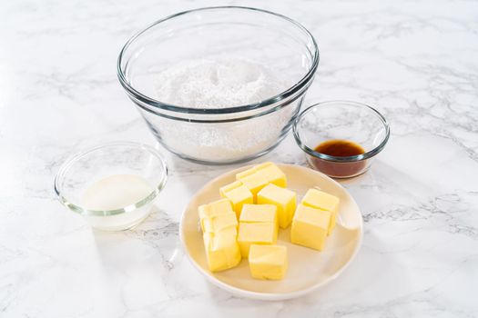 Measured ingredients in glass mixing bowls to make ombre pink buttercream frosting.