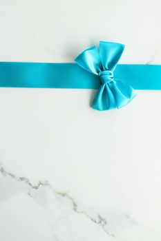 Holiday decor, feminine design and flatlay concept - Blue silk ribbon on marble, top view