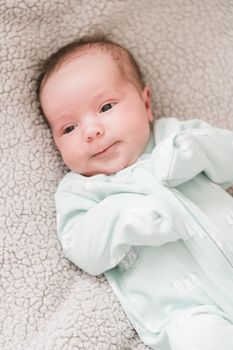 Lifestyle portrait of a newborn, three weeks old baby girl.