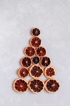 Christmas tree made of dry orange slices, minimalism, zero waste idea, top view