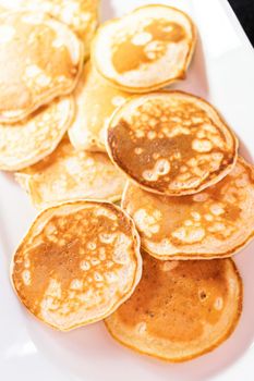 Freshly made small pancakes on a kefir base.