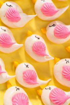 Freshly baked Easter meringue cookies in the shape of birds.