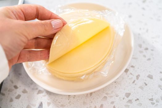 Filling empanada dough with blueberry pie filling to make sweet empanadas with blueberries.