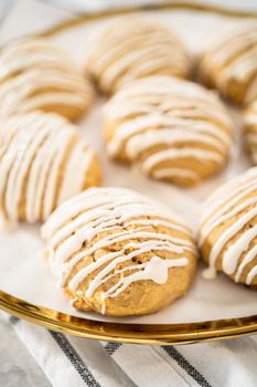 Freshly baked chocolate cookies with eggnog scones with a white chocolate drizzle on top.