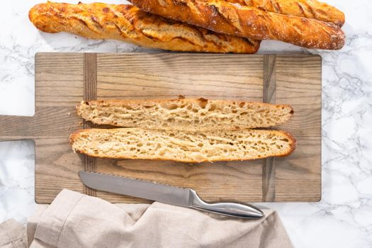 Flat lay. Freshly baked small French baguette bread.